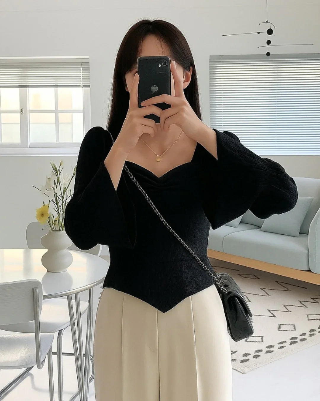 Ribbed Long Sleeve Flared Hem Statement Top in Black